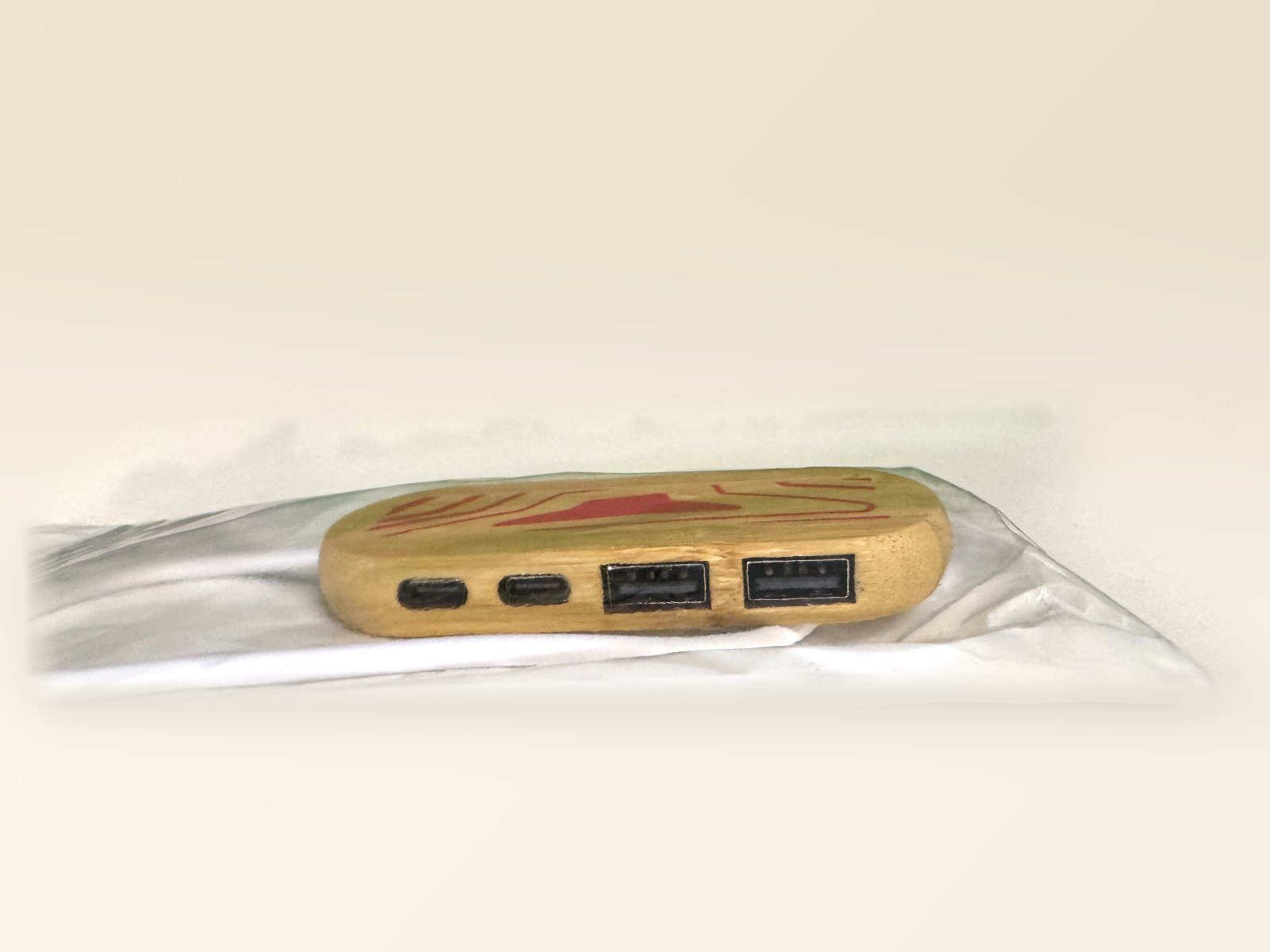 Wood-look bamboo 2-port USB-A hub with red printed top, in its clear bag